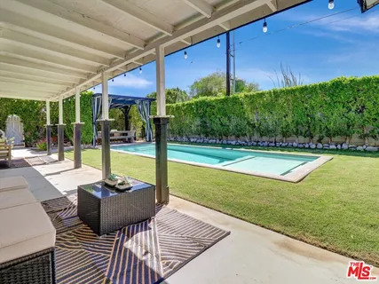 a view of a swimming pool with a patio