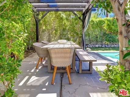 a view of house with swimming pool and porch