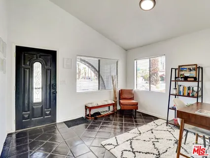 a living room with furniture a window and a painting on the wall