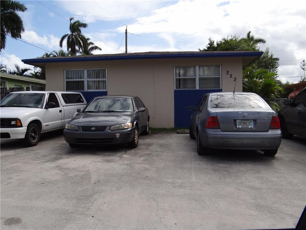 223 Southwest 9th Street Hallandale Beach, FL 33009 - Photo 2 of 3 a car parked in parking