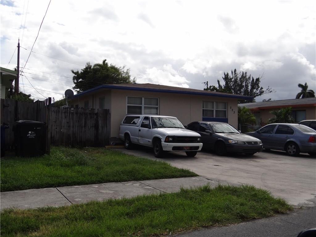 223 Southwest 9th Street Hallandale Beach, FL 33009 - Photo 3 of 3 a couple of cars parked in front of a house