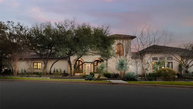 a front view of house with yard and green space