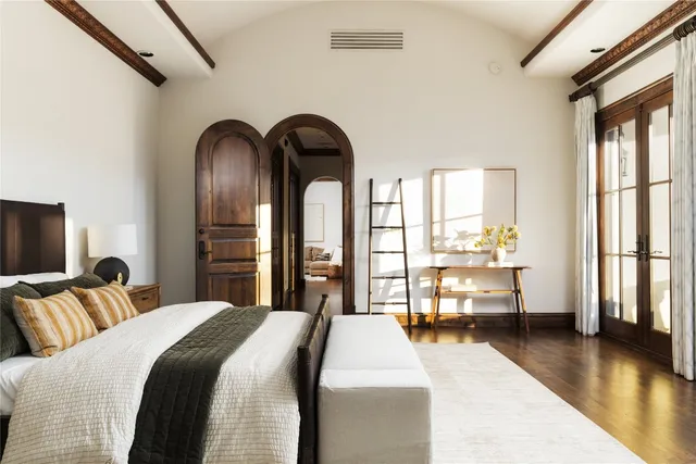 a bedroom with bed and a large window