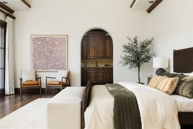 a bedroom with a bed and a television