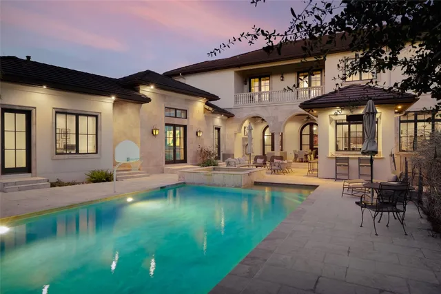 a view of a house with swimming pool and sitting area