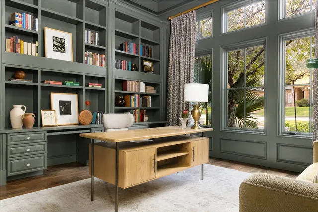 a room with a table and a bookshelf