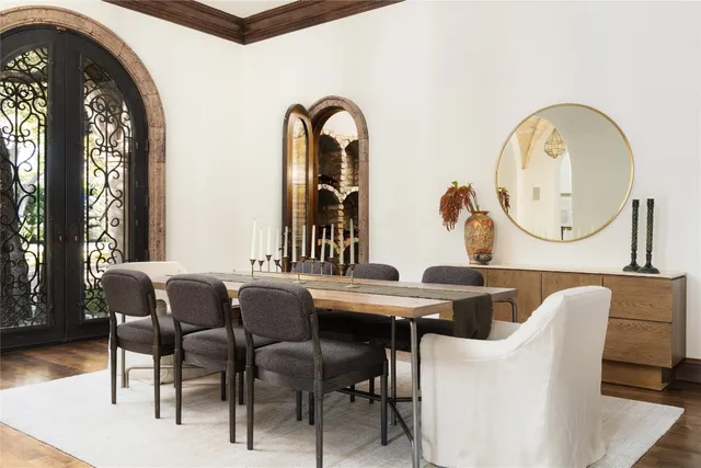 a dining room with furniture and a mirror