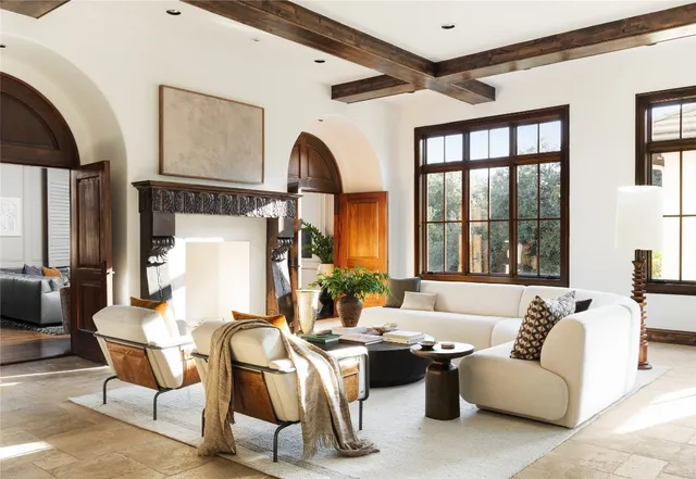 a living room with furniture and floor to ceiling windows