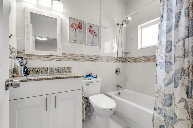 a living room with furniture and a wall painting