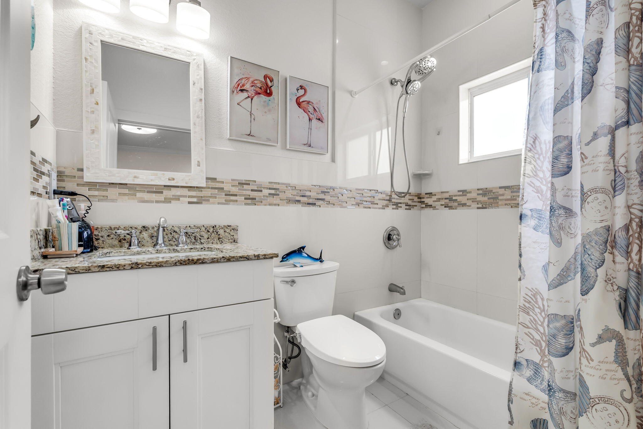 22 Tarpon Avenue Key Largo, FL 33037 - Photo 20 of 43 a bathroom with a granite countertop sink mirror vanity bathtub and a toilet