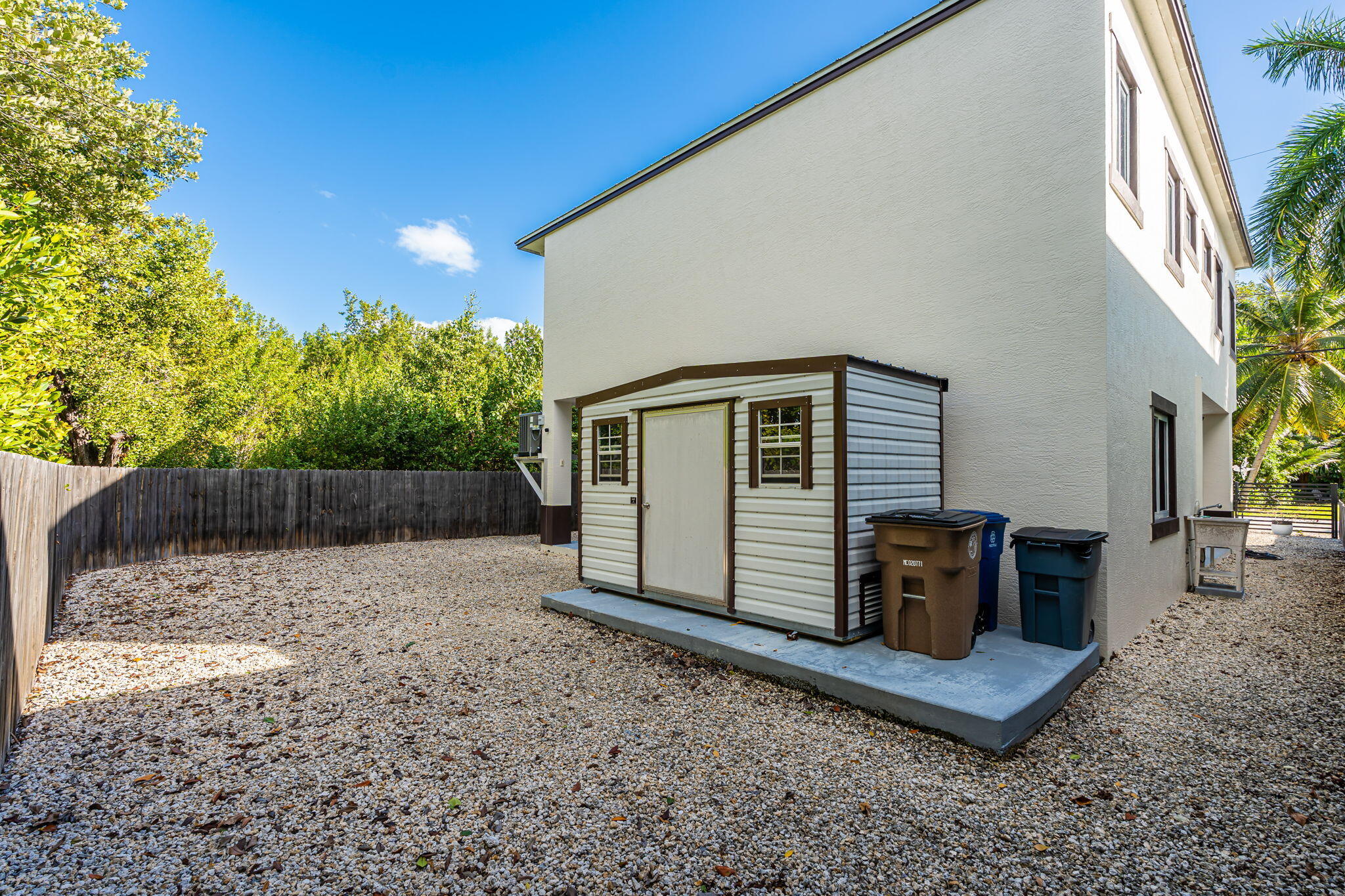 22 Tarpon Avenue Key Largo, FL 33037 - Photo 23 of 43 a view of backyard with wooden fence and trees