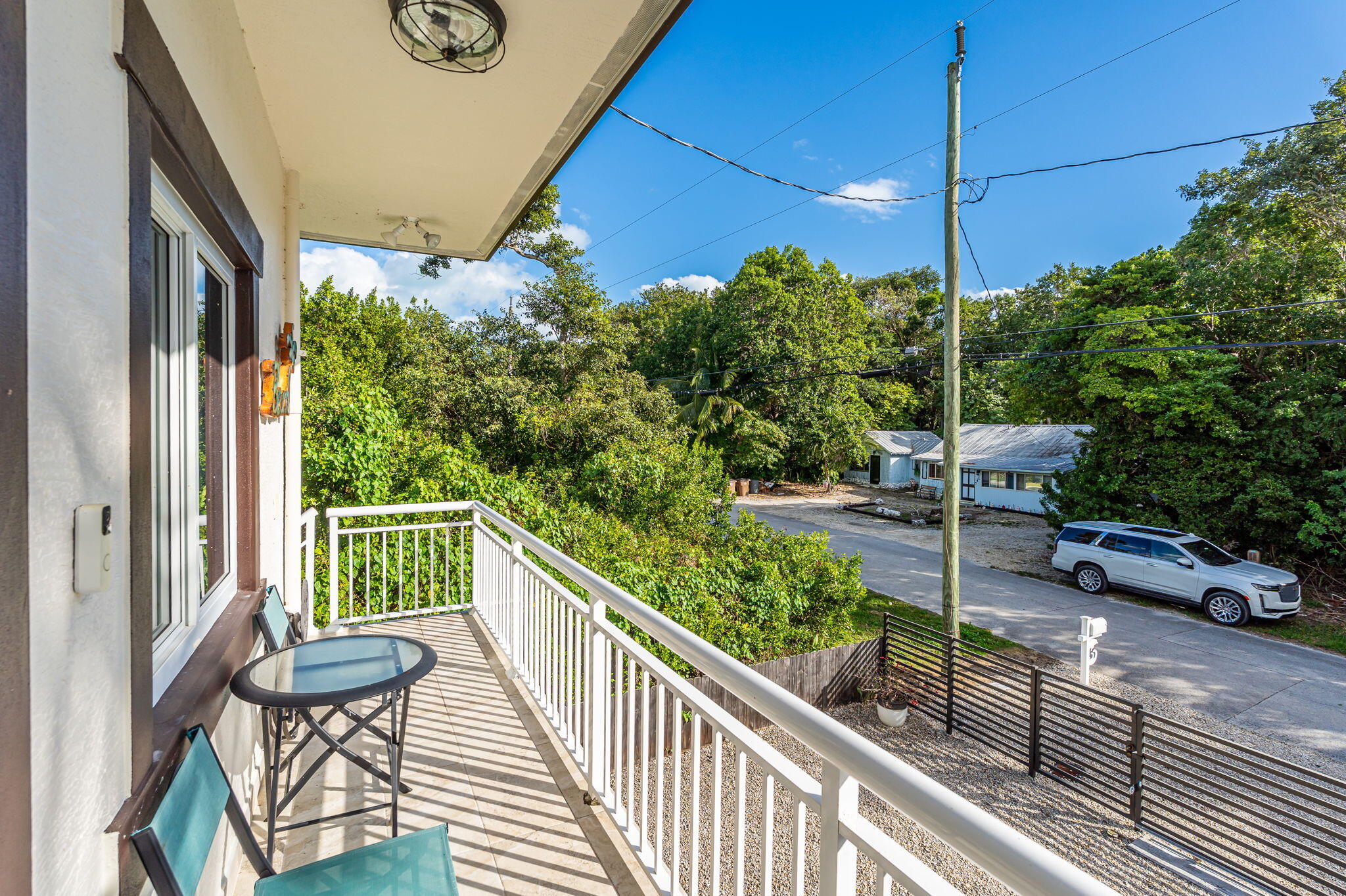 22 Tarpon Avenue Key Largo, FL 33037 - Photo 3 of 43 a view of a chair and tables in the balcony