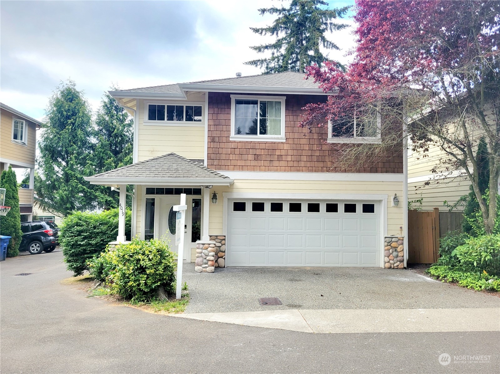 4019 Northeast 14th Place Renton, WA 98056 - Photo 1 of 21 a front view of a house with a garden
