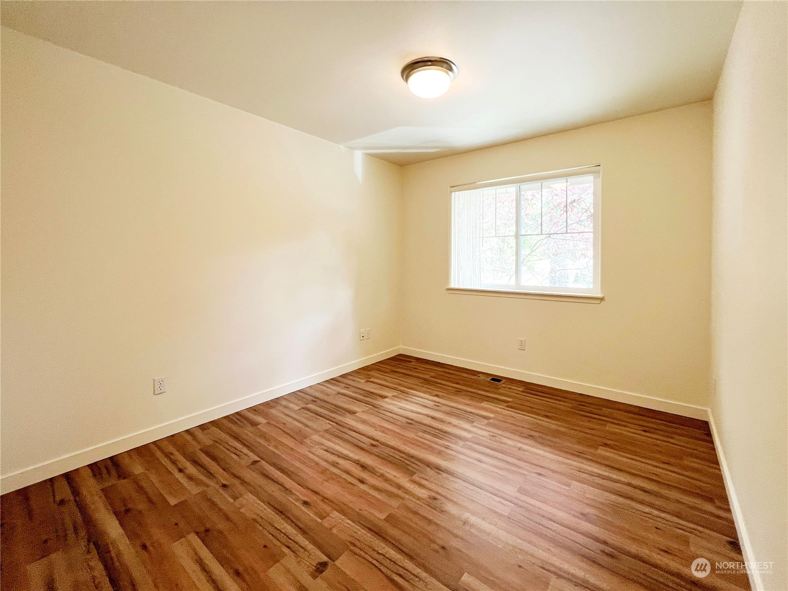 4019 Northeast 14th Place Renton, WA 98056 - Photo 14 of 21 an empty room with wooden floor and windows