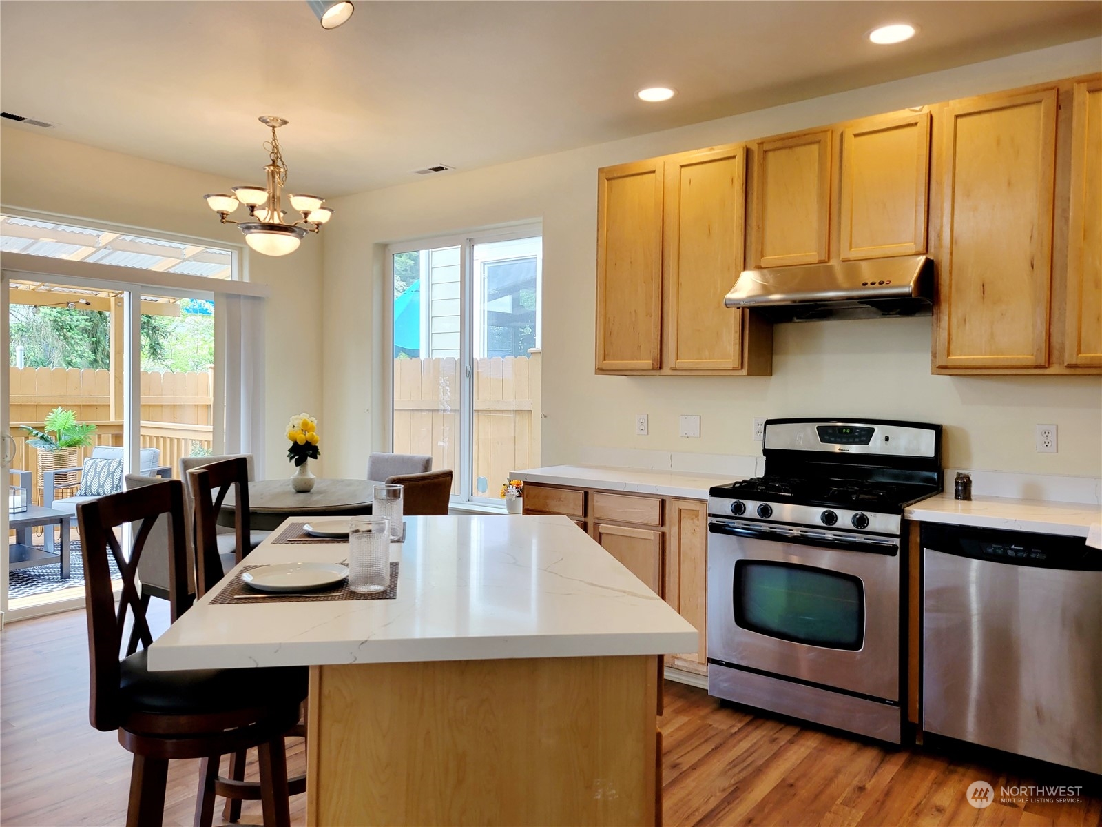 4019 Northeast 14th Place Renton, WA 98056 - Photo 8 of 21 a kitchen with a stove a sink a dining table and chairs