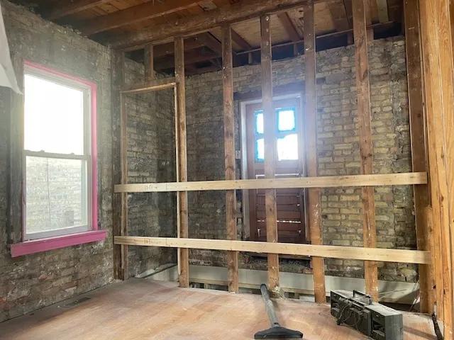 a bathroom with a glass door shower and a mirror