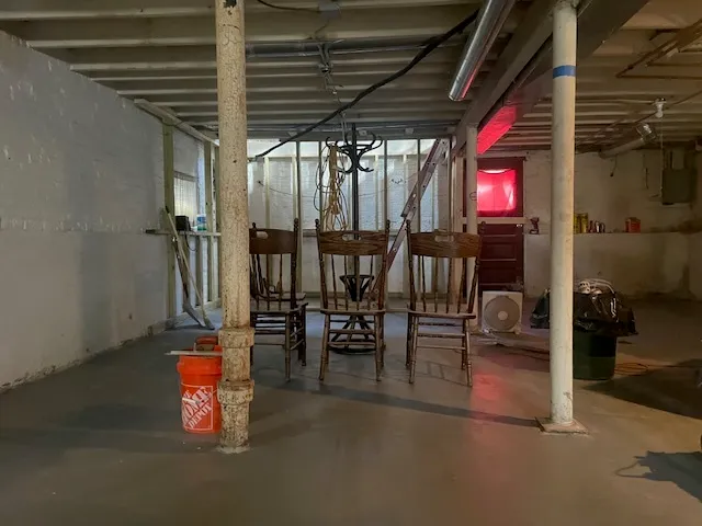 a living room with furniture and a gym machine