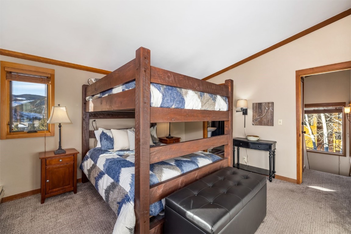 410 Tennis Club Road, Unit 1317 Keystone, CO 80435 - Photo 17 of 47 Bedroom with light carpet, vaulted ceiling, and ornamental molding