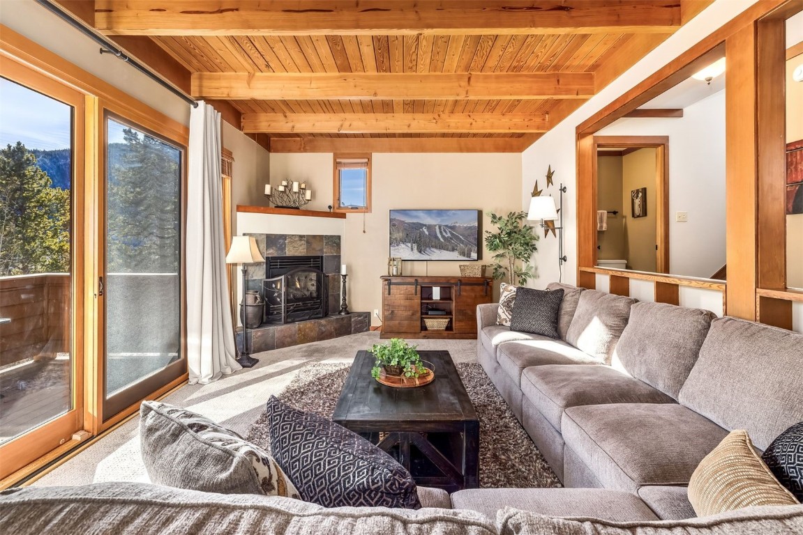 410 Tennis Club Road, Unit 1317 Keystone, CO 80435 - Photo 19 of 47 Living room with carpet flooring, a fireplace, and a wooden ceiling with exposed beams