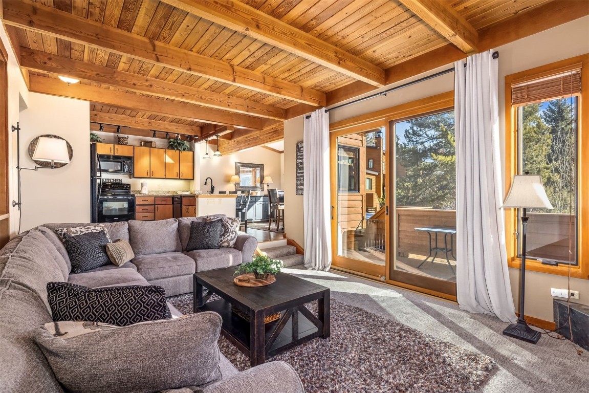 410 Tennis Club Road, Unit 1317 Keystone, CO 80435 - Photo 32 of 47 Carpeted living room with a wood ceiling with exposed beams