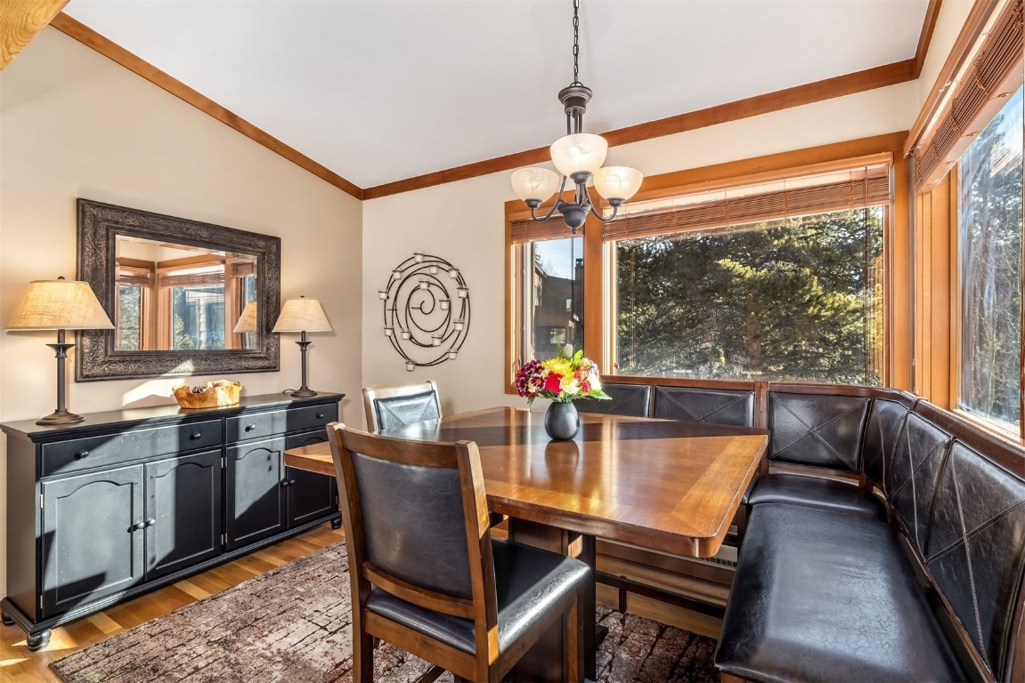 410 Tennis Club Road, Unit 1317 Keystone, CO 80435 - Photo 5 of 47 Dining area featuring light wood-type flooring, crown molding, lofted ceiling, and a chandelier