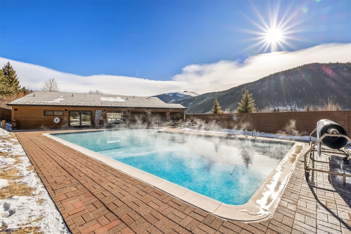 410 Tennis Club Road, Unit 1317 Keystone, CO 80435 - Photo 8 of 47 Community pool with a patio, a fenced backyard, and a mountain view