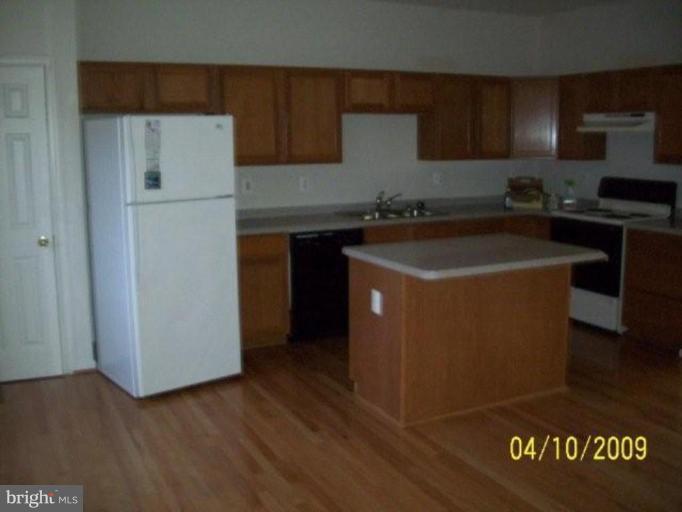 841 Middle River Road Middle River, MD 21220 - Photo 2 of 9 a kitchen with a sink a stove and a refrigerator