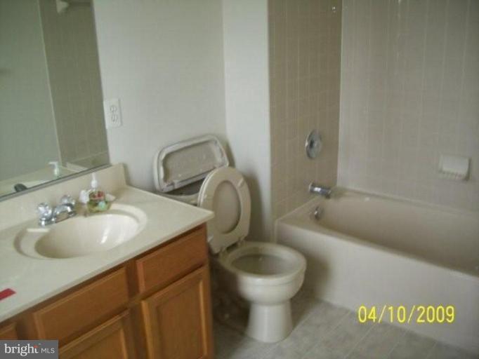 841 Middle River Road Middle River, MD 21220 - Photo 4 of 9 a bathroom with a toilet sink and mirror