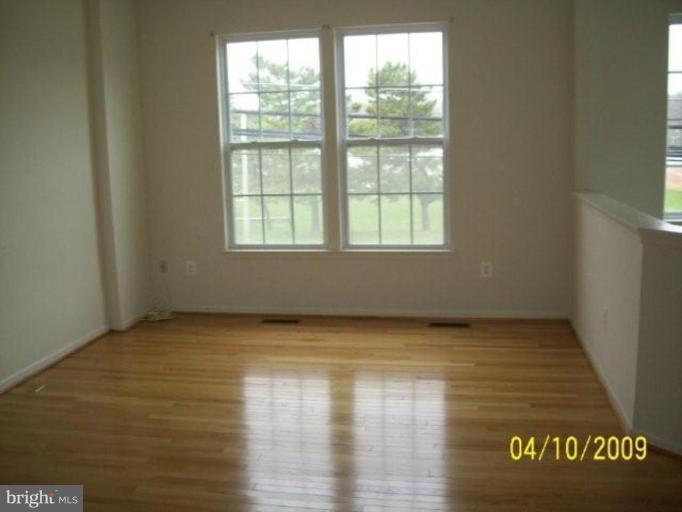 841 Middle River Road Middle River, MD 21220 - Photo 8 of 9 a view of an empty room with wooden floor and a window