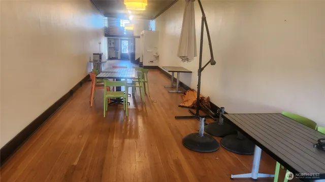 a view of entryway and hall with wooden floor