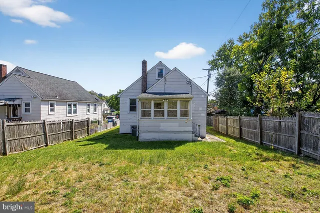 a view of a house with a yard and sitting area