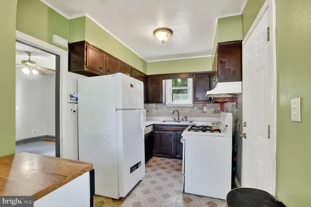 a kitchen with stainless steel appliances a refrigerator stove and sink