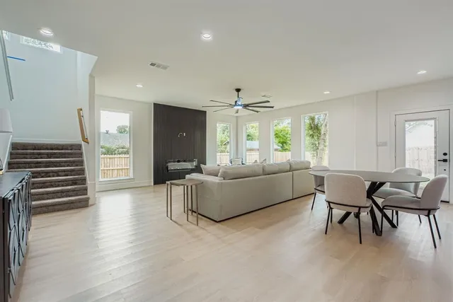a living room with furniture and a wooden floor