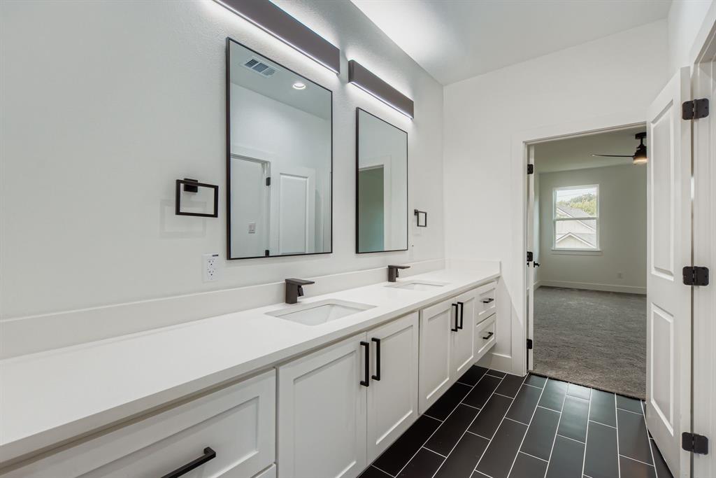 12 Climbing Tree Drive Kaufman, TX 75142 - Photo 21 of 28 a bathroom with a double vanity sink and mirror