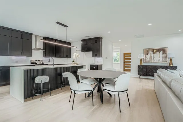 a dining room with furniture a window and a flat screen tv