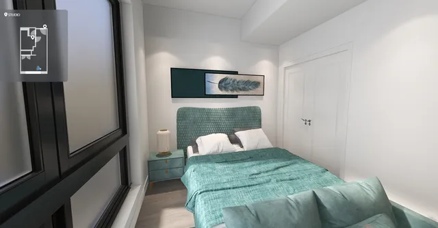 a bedroom with a bed and a television