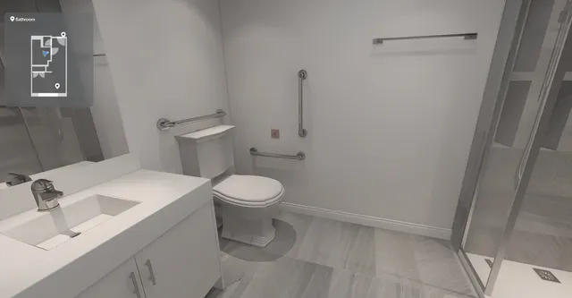 a white toilet sitting next to a bathroom sink