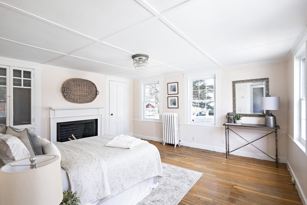 206 West Street Reading, MA 01867 - Photo 14 of 28 a bedroom with a bed and a fireplace