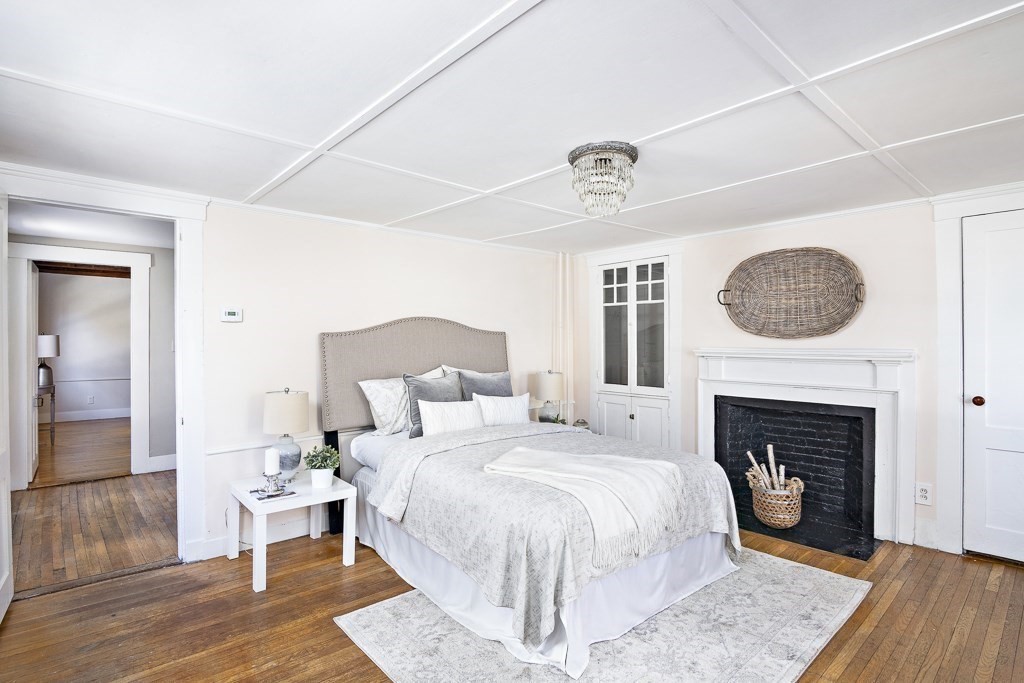 206 West Street Reading, MA 01867 - Photo 15 of 28 a bed room with a bed and a fireplace