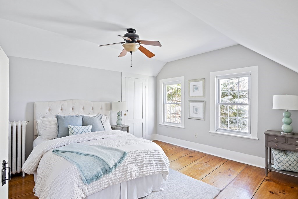 206 West Street Reading, MA 01867 - Photo 18 of 28 a bedroom with a bed and a chandelier