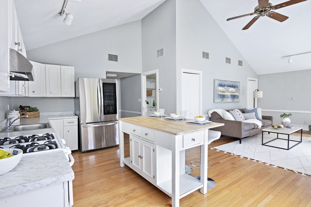 206 West Street Reading, MA 01867 - Photo 2 of 28 a kitchen with a stove a refrigerator and a stove top oven