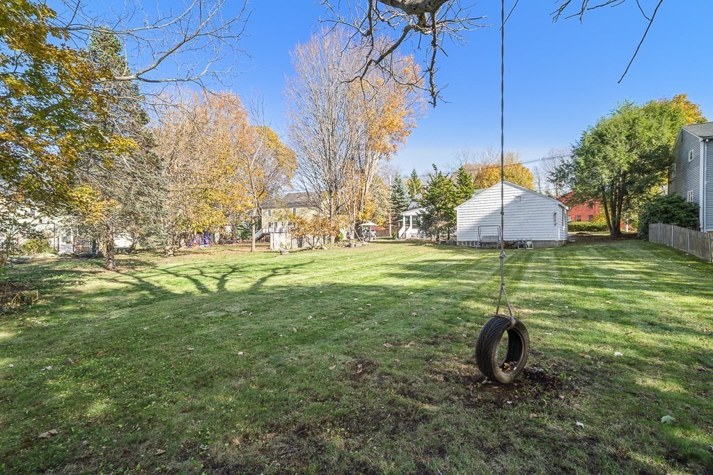 206 West Street Reading, MA 01867 - Photo 26 of 28 a backyard of a house with lots of green space
