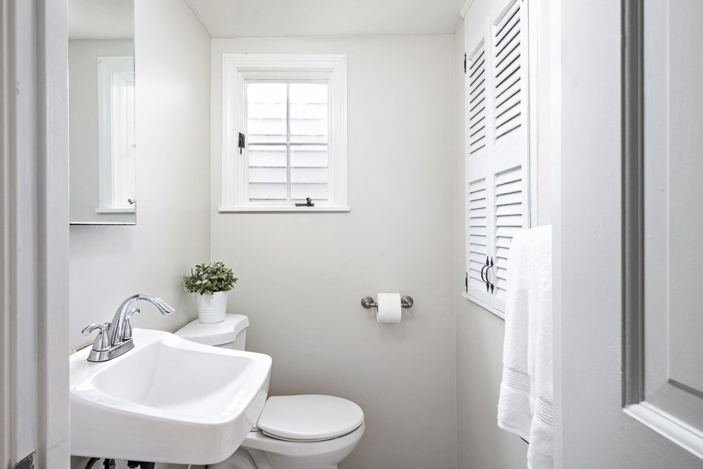 206 West Street Reading, MA 01867 - Photo 7 of 28 a bathroom with a toilet a sink and a window