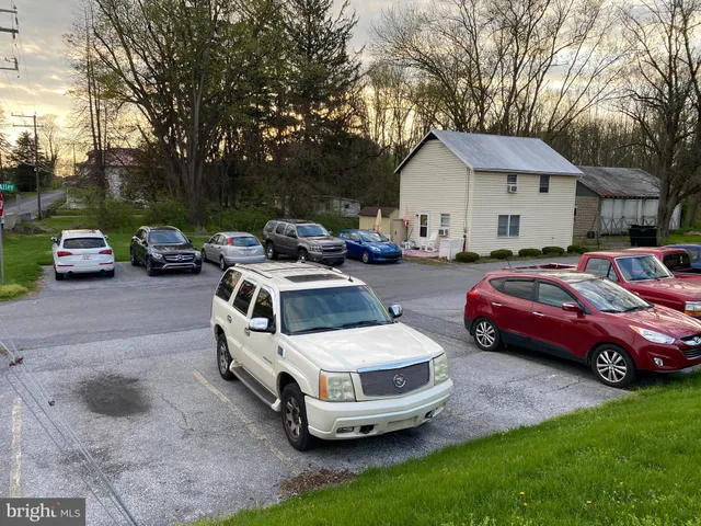 a couple of cars parked in front of a house