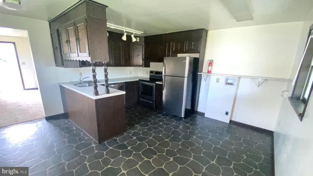 a kitchen with stainless steel appliances a refrigerator and a sink