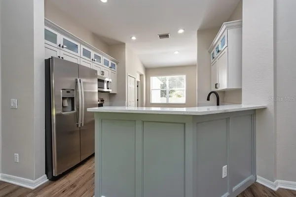 a kitchen with stainless steel appliances granite countertop a refrigerator and a sink