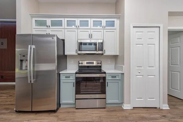 a kitchen with stainless steel appliances granite countertop a refrigerator and a stove