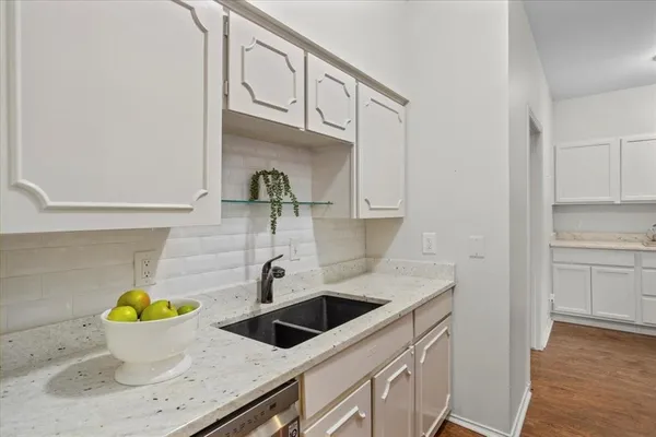 a kitchen with a sink and cabinets