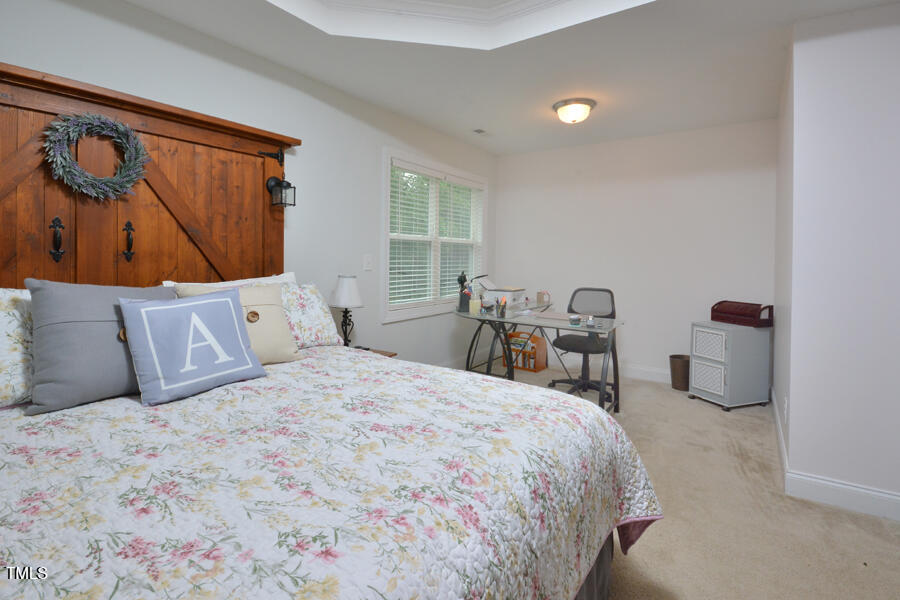 195 Timberwind Road Franklinton, NC 27525 - Photo 22 of 28 a bed room with a bed and a chair