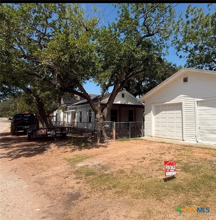 202 Clark Street Yoakum, TX 77995 - Photo 13 of 15 a front view of a house with a yard covered in snow